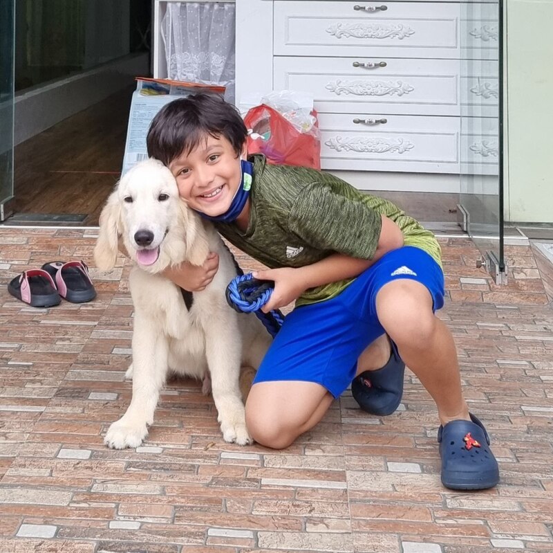 Super happy teenager bringing his new puppy in singapore